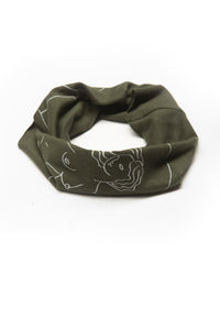 Get Up Stand Up Multi Use Headband/Face Mask by Alexandra Velasco in Olive Green - Nude Woman Print with text "La suavidad de la luna. La fuerza del sol." - rolled like neck gaiter - Olive Green