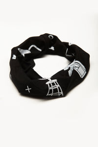 Dada by Deux Goods - black fabric with white print - rolled up as a neck gaiter